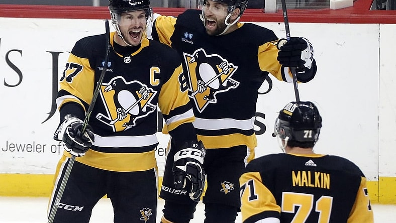 Mar 7, 2023; Pittsburgh, Pennsylvania, USA;  Pittsburgh Penguins center Sidney Crosby (87) reacts with left wing Jason Zucker (16) and center Evgeni Malkin (71) after scoring the game winning power play goal in overtime against the Columbus Blue Jackets at PPG Paints Arena. Pittsburgh won 5-4 in overtime. Mandatory Credit: Charles LeClaire-USA TODAY Sports