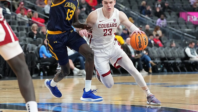 Mar 8, 2023; Las Vegas, NV, USA; Washington State Cougars forward Andrej Jakimovski (23) dribbles against California Golden Bears forward Kuany Kuany (13) during the second half at T-Mobile Arena. Mandatory Credit: Stephen R. Sylvanie-USA TODAY Sports