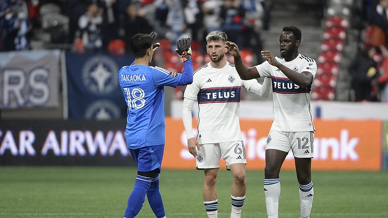 Mar 8, 2023; Vancouver, British Columbia, CAN;  Vancouver Whitecaps FC goalkeeper Yohei Takaoka (18) celebrates the win with defender Tristan Blackmon (6) and defender Karifa Yao (12) during the second half at BC Place Stadium. Mandatory Credit: Anne-Marie Sorvin-USA TODAY Sports