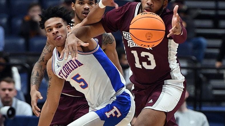 Mar 9, 2023; Nashville, TN, USA; Mississippi State Bulldogs forward Will McNair Jr. (13) and Florida Gators guard Will Richard (5) battle for a loose ball during the first half at Bridgestone Arena. Mandatory Credit: Christopher Hanewinckel-USA TODAY Sports