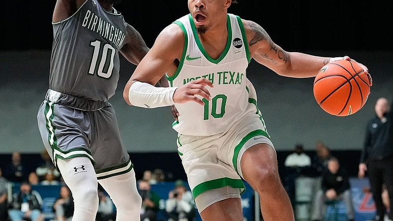 Mar 10, 2023; Frisco, TX, USA;  North Texas Mean Green guard Kai Huntsberry (10) drives to the basket past UAB Blazers guard Jordan Walker (10) during the second half at Ford Center at The Star. Mandatory Credit: Chris Jones-USA TODAY Sports