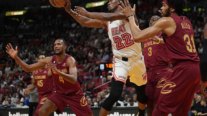 Mar 10, 2023; Miami, Florida, USA;  Miami Heat forward Jimmy Butler (22) passes the ball as Cleveland Cavaliers center Jarrett Allen (31) defends during the first half at Miami-Dade Arena. Mandatory Credit: Jim Rassol-USA TODAY Sports