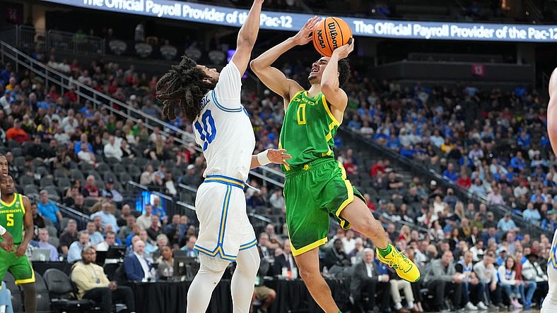 Mar 10, 2023; Las Vegas, NV, USA; Oregon Ducks guard Will Richardson (0) shoots against UCLA Bruins guard Tyger Campbell (10) during the first half at T-Mobile Arena. Mandatory Credit: Stephen R. Sylvanie-USA TODAY Sports