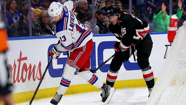 Mar 11, 2023; Buffalo, New York, USA;  New York Rangers left wing Alexis Lafreni  re (13) controls the puck as Buffalo Sabres defenseman Owen Power (25) defends during the first period at KeyBank Center. Mandatory Credit: Timothy T. Ludwig-USA TODAY Sports
