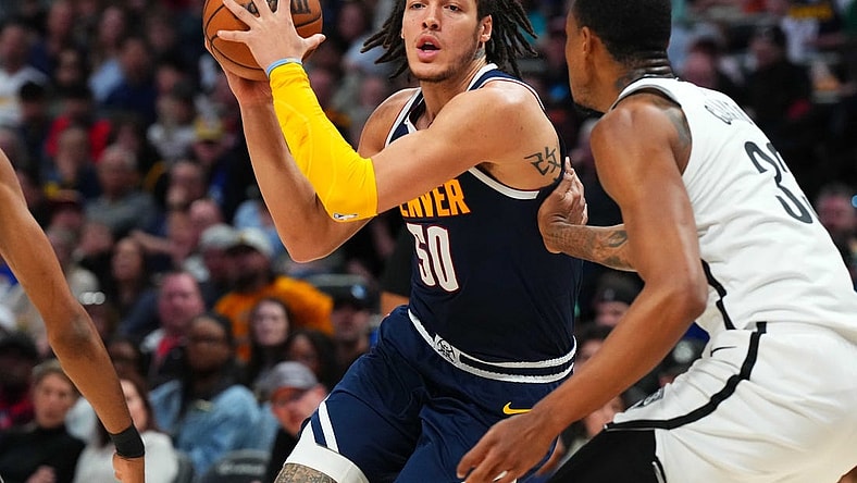 Mar 12, 2023; Denver, Colorado, USA; Denver Nuggets forward Aaron Gordon (50) drives at Brooklyn Nets center Nic Claxton (33) in the second quarter at Ball Arena. Mandatory Credit: Ron Chenoy-USA TODAY Sports