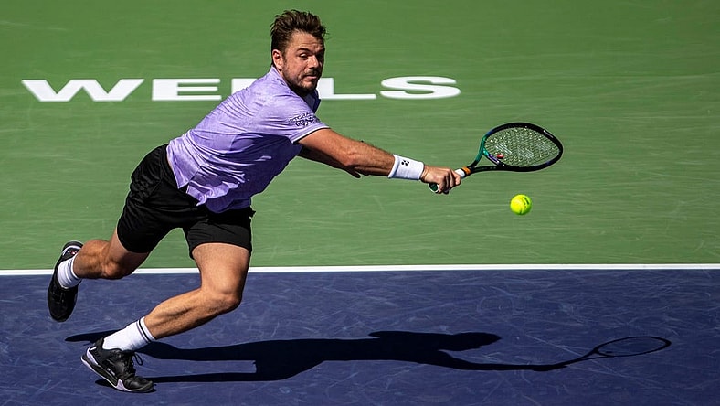 Stan Wawrinka of Switzerland runs up for a return to Holger Rune of Denmark during third-round their match at the BNP Paribas Open at the Indian Wells Tennis Garden in Indian Wells, Calif., Monday, March 13, 2023.