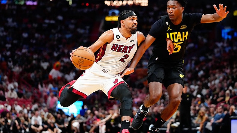 Mar 13, 2023; Miami, Florida, USA; Miami Heat guard Gabe Vincent (2) dribbles the ball past Utah Jazz center Damian Jones (15) during the third quarter at Miami-Dade Arena. Mandatory Credit: Rich Storry-USA TODAY Sports