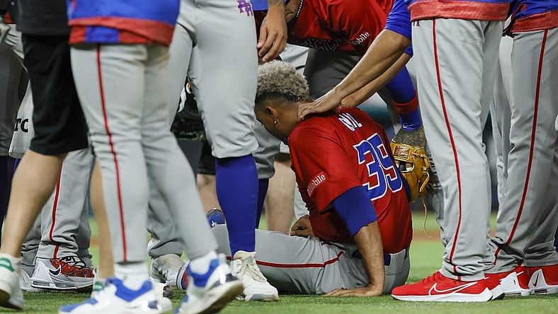 Mar 15, 2023; Miami, Florida, USA; Puerto Rico pitcher Edwin Diaz (39) sits on the field after an apparent leg injury during the team celebration against Dominican Republic at LoanDepot Park. Mandatory Credit: Sam Navarro-USA TODAY Sports