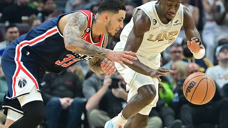 Mar 17, 2023; Cleveland, Ohio, USA; Washington Wizards forward Kyle Kuzma (33) and Cleveland Cavaliers guard Caris LeVert (3) go for a loose ball during the first half at Rocket Mortgage FieldHouse. Mandatory Credit: Ken Blaze-USA TODAY Sports