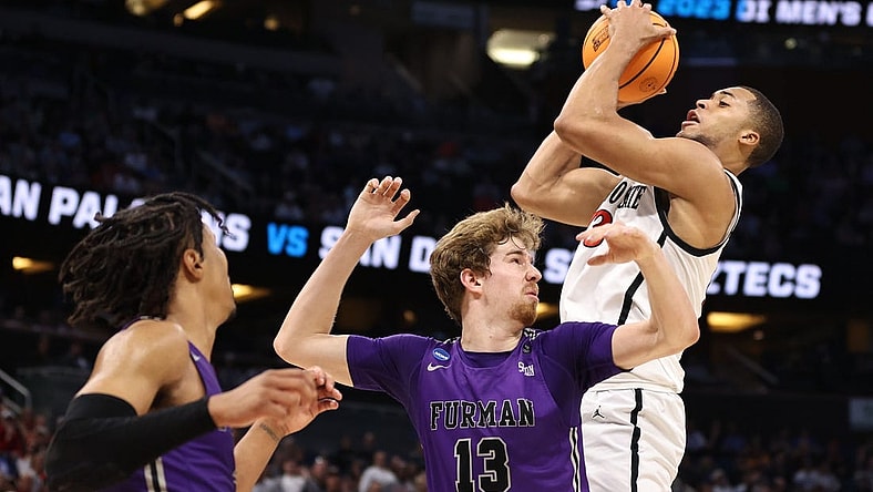 Mar 18, 2023; Orlando, FL, USA; San Diego State Aztecs forward Jaedon LeDee (13) pulls down a rebound against Furman Paladins forward Garrett Hien (13) during the first half in the second round of the 2023 NCAA Tournament at Legacy Arena. Mandatory Credit: Matt Pendleton-USA TODAY Sports