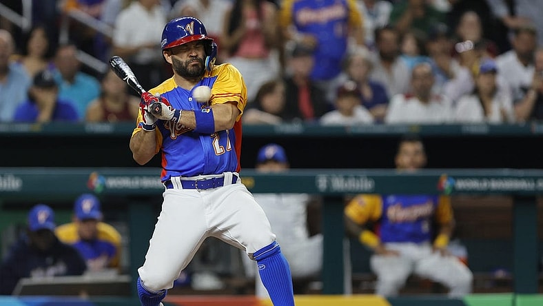 Mar 18, 2023; Miami, Florida, USA; Venezuela second baseman Jose Altuve (27) gets hit by a pitch during the fifth inning against the USA at LoanDepot Park. Mandatory Credit: Sam Navarro-USA TODAY Sports