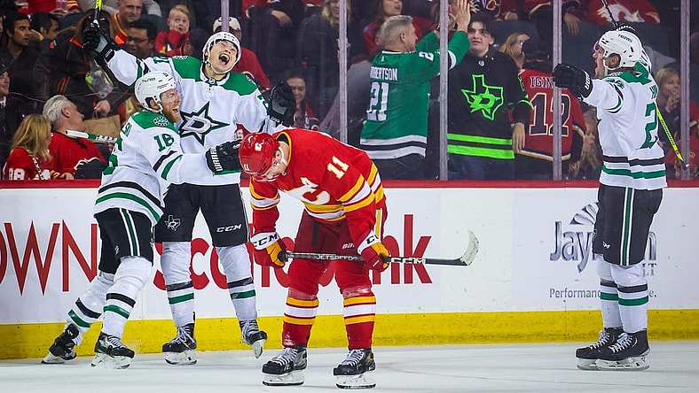Mar 18, 2023; Calgary, Alberta, CAN; Dallas Stars left wing Jason Robertson (21) celebrates his goal with teammates against the Calgary Flames during the overtime period at Scotiabank Saddledome. Mandatory Credit: Sergei Belski-USA TODAY Sports