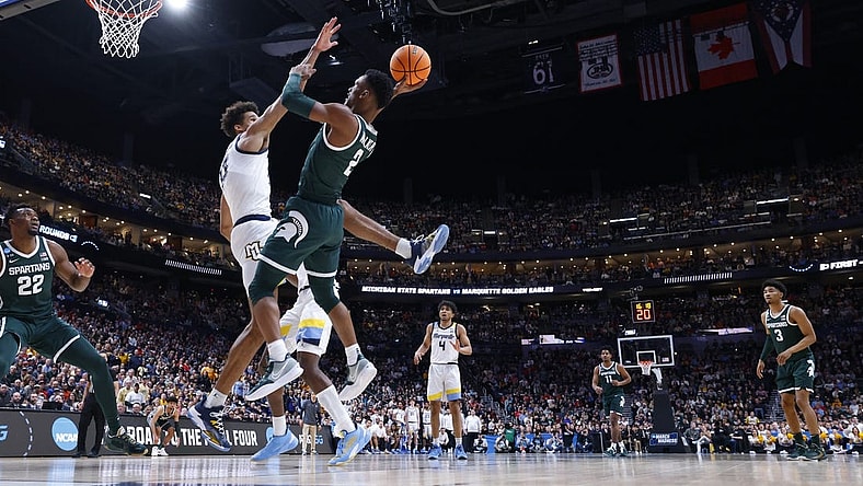 Mar 19, 2023; Columbus, OH, USA; Michigan State Spartans guard Tyson Walker (2) shoots the ball over Marquette Golden Eagles forward Oso Ighodaro (13) in the second half at Nationwide Arena. Mandatory Credit: Rick Osentoski-USA TODAY Sports