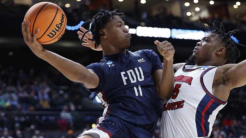 Mar 19, 2023; Columbus, OH, USA; Fairleigh Dickinson Knights forward Sean Moore (11) looks tot play the ball defended by Florida Atlantic Owls guard Bryan Greenlee (4) in the first half at Nationwide Arena. Mandatory Credit: Rick Osentoski-USA TODAY Sports