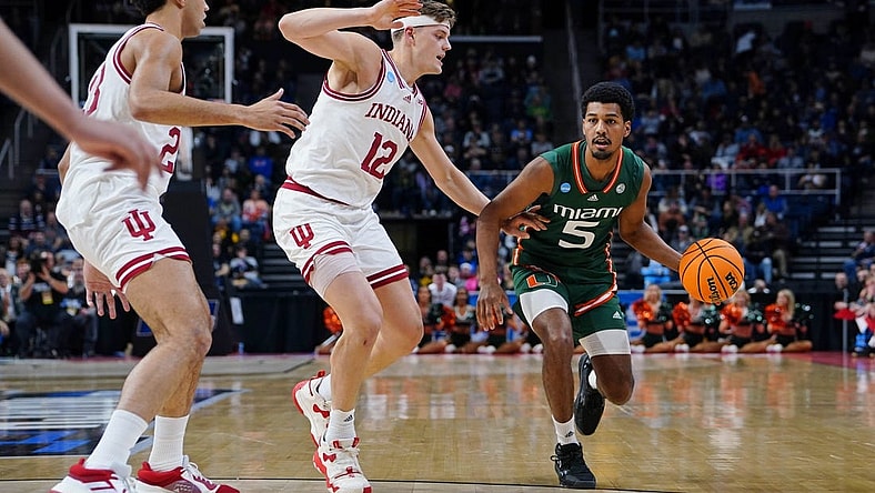 Mar 19, 2023; Albany, NY, USA; Miami (Fl) Hurricanes guard Harlond Beverly (5) drives to the basket against Indiana Hoosiers forward Miller Kopp (12) during the first half at MVP Arena. Mandatory Credit: Gregory Fisher-USA TODAY Sports