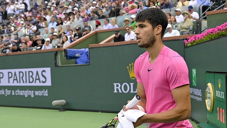 Mar 19, 2023; Indian Wells, CA, USA;  Carlos Alcaraz (ESP) wipes off his racket during the match as he defeated Daniil Medvedev (RUS) in the men   s final of the BNP Paribas Open at the Indian Wells Tennis Garden. Mandatory Credit: Jayne Kamin-Oncea-USA TODAY Sports