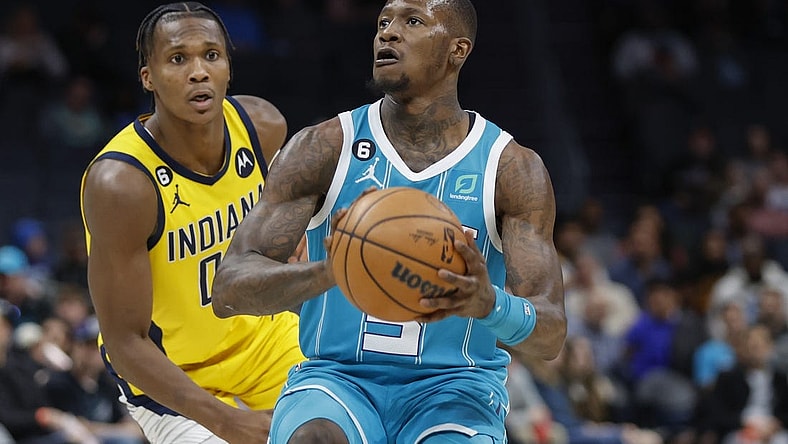 Mar 20, 2023; Charlotte, North Carolina, USA; Charlotte Hornets guard Terry Rozier (3) looks to shoot ahead of Indiana Pacers guard Bennedict Mathurin (00) during the second half at Spectrum Center. The Charlotte Hornets won 115-109. Mandatory Credit: Nell Redmond-USA TODAY Sports