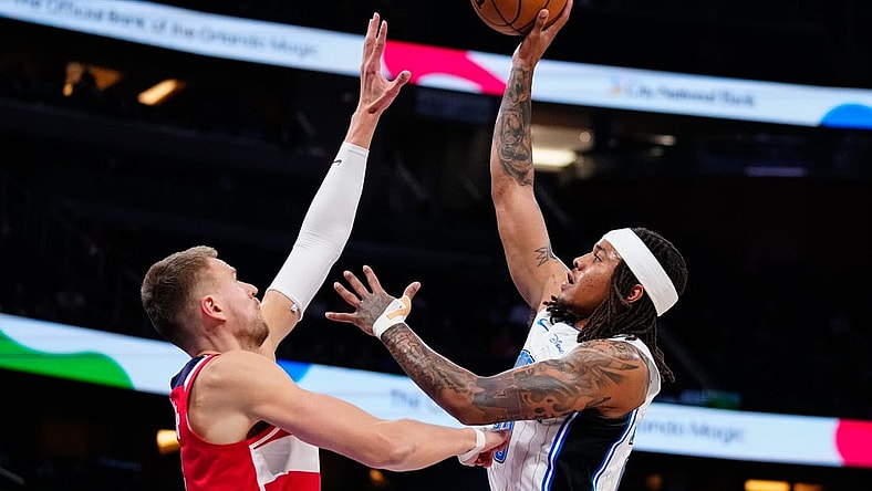 Mar 21, 2023; Orlando, Florida, USA; Orlando Magic guard Markelle Fultz (20) shoots over Washington Wizards center Kristaps Porzingis (6) during the first quarter at Amway Center. Mandatory Credit: Rich Storry-USA TODAY Sports