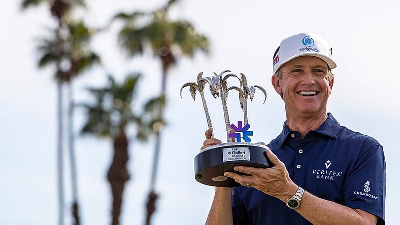 PGA TOUR Champions player David Toms holds up the Galleri Classic trophy after winning the inaugural playing of the tournament on the Dinah Shore Tournament Course in Rancho Mirage, Calif., Sunday, March 26, 2023. Toms finished 16-under overall after hitting 7-under for the final round.