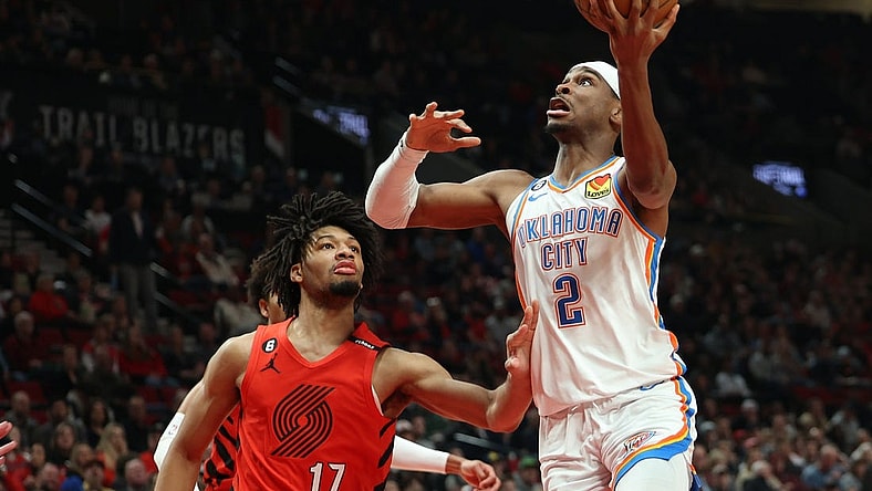 Mar 26, 2023; Portland, Oregon, USA;  Oklahoma City Thunder guard Shai Gilgeous-Alexander (2) shoots the ball over Portland Trail Blazers guard Shaedon Sharpe (17) in the first half at Moda Center. Mandatory Credit: Jaime Valdez-USA TODAY Sports