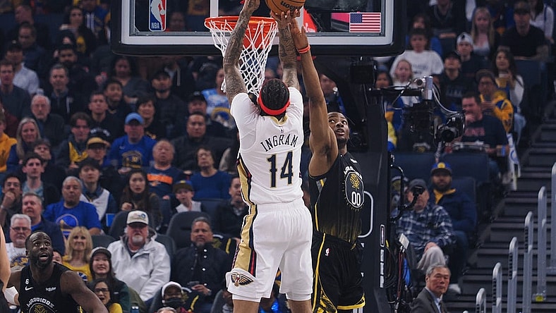 Mar 28, 2023; San Francisco, California, USA; New Orleans Pelicans small forward Brandon Ingram (14) scores a basket against Golden State Warriors forward Jonathan Kuminga (00) during the first quarter at Chase Center. Mandatory Credit: Kelley L Cox-USA TODAY Sports