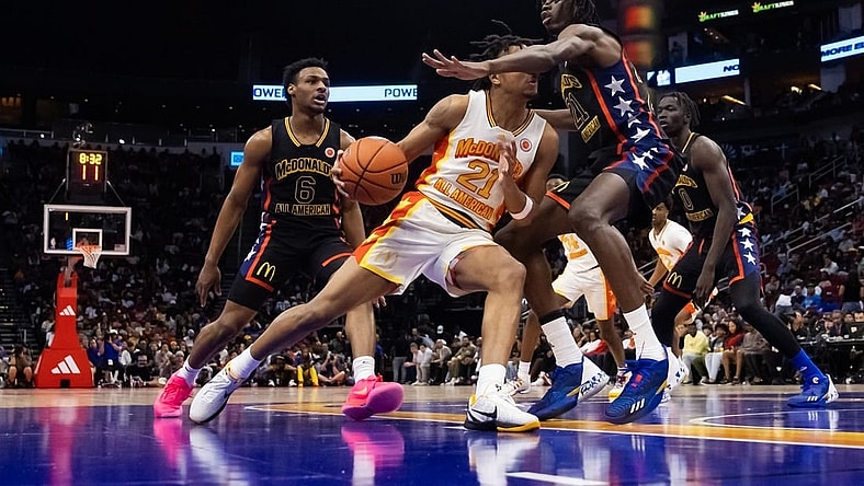 Mar 28, 2023; Houston, TX, USA; East guard DJ Wagner (center) drives to the basket against West forward Baye Fall during the McDonald's All American Boy's high school basketball game at Toyota Center. Mandatory Credit: Mark J. Rebilas-USA TODAY Sports