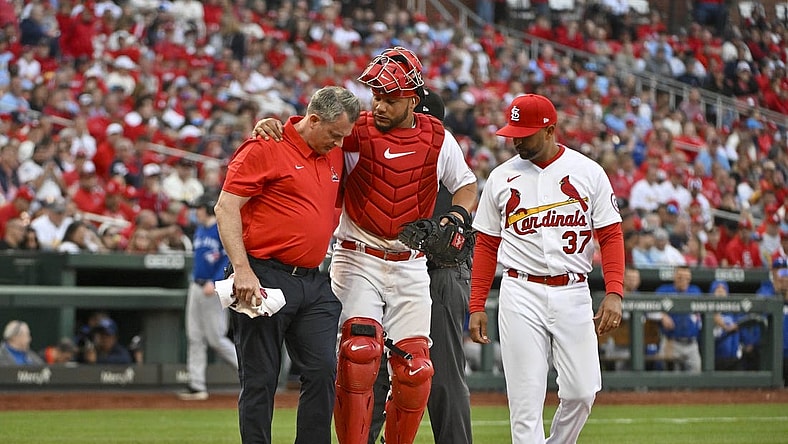 Mar 30, 2023; St. Louis, Missouri, USA; St. Louis Cardinals catcher Willson Contreras (40) is helped off the field by a trainer after taking a ball off the the knee during the eighth inning against the Toronto Blue Jays at Busch Stadium. Mandatory Credit: Jeff Curry-USA TODAY Sports