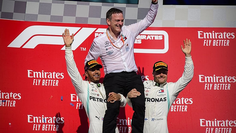 Nov 3, 2019; Austin, TX, USA; Mercedes AMG Petronas Motorsport designer James Allison is lifted up by Mercedes AMG Petronas Motorsport driver Lewis Hamilton (left) of Great Britain and Mercedes AMG Petronas Motorsport driver Valtteri Bottas (right) of Finland during the United States Grand Prix at Circuit of the Americas. Mandatory Credit: Jerome Miron-USA TODAY Sports