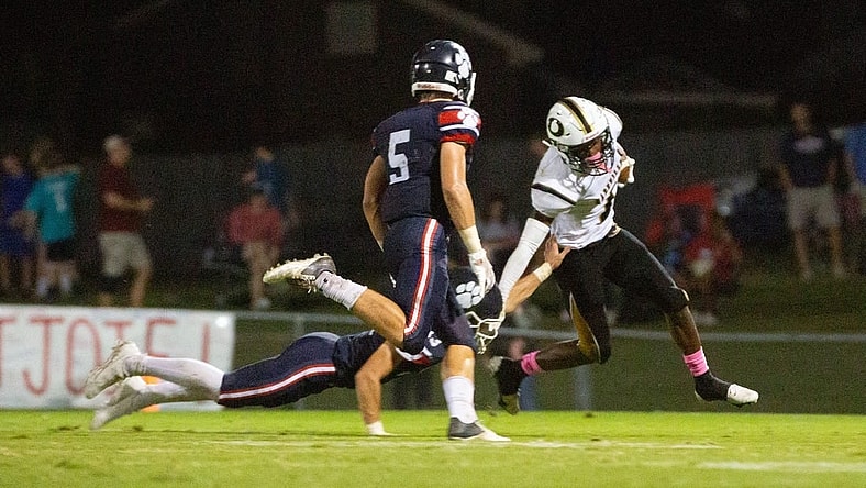 Dadeville's Philstavious Dowdell (7) tries to fend off Trinity's Thompson Mcnees (15) as Seawell Mckee (5) swoops in for a tackle on October 08, 2021.

1008 Trinity V Dadeville