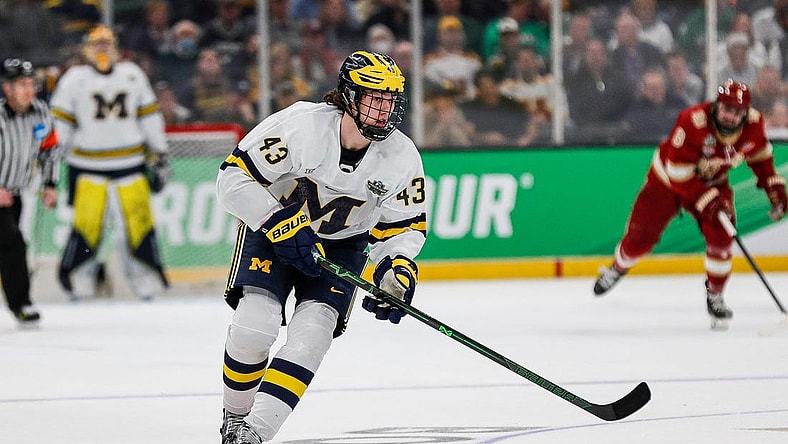 Michigan defenseman Luke Hughes (43) looks to pass against Denver during the first period of the Frozen Four semifinal at the TD Garden in Boston, Mass. on Thursday., April 7, 2022.