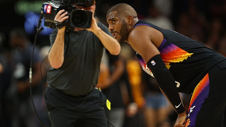 Apr 26, 2022; Phoenix, Arizona, USA; A TV cameraman records Phoenix Suns guard Chris Paul (3) against the New Orleans Pelicans during game five of the first round for the 2022 NBA playoffs at Footprint Center. Mandatory Credit: Mark J. Rebilas-USA TODAY Sports