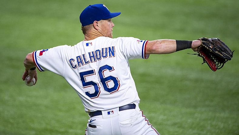 Jul 16, 2022; Arlington, Texas, USA; Texas Rangers left fielder Kole Calhoun (56) throws the ball into the infield during the sixth inning against the Seattle Mariners at Globe Life Field. Mandatory Credit: Jerome Miron-USA TODAY Sports