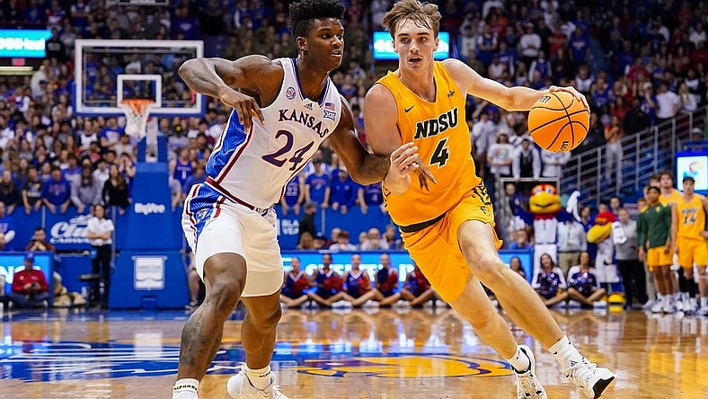 Nov 10, 2022; Lawrence, Kansas, USA; North Dakota State Bison forward Grant Nelson (4) drives against Kansas Jayhawks forward K.J. Adams Jr. (24) during the first half at Allen Fieldhouse. Mandatory Credit: Jay Biggerstaff-USA TODAY Sports