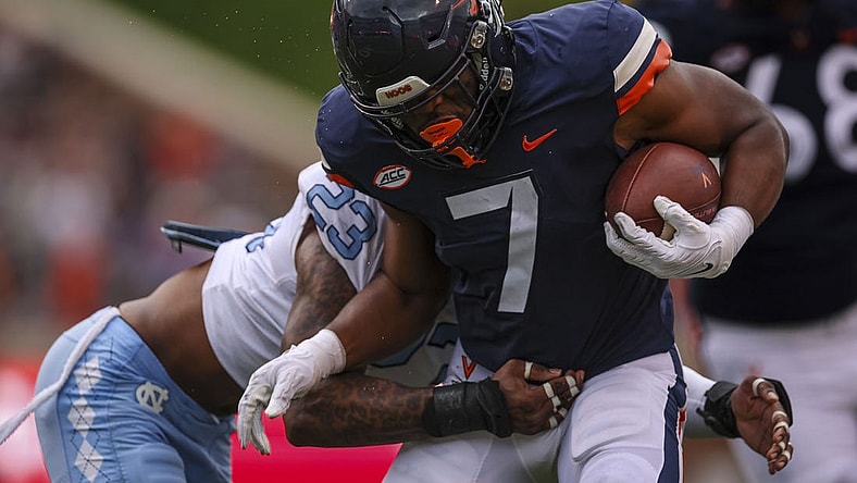 Nov 5, 2022; Charlottesville, Virginia, USA; Virginia Cavaliers running back Mike Hollins (7) carries the ball against the North Carolina Tar Heels during the first half at Scott Stadium. Mandatory Credit: Scott Taetsch-USA TODAY Sports