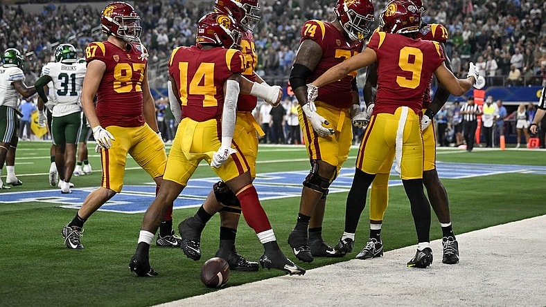 Jan 2, 2023; Arlington, Texas, USA; USC Trojans wide receiver Michael Jackson III (9) and offensive lineman Courtland Ford (74) and running back Raleek Brown (14) and tight end Lake McRee (87) celebrate after Jackson scores a touchdown against the Tulane Green Wave during the first half in the 2023 Cotton Bowl at AT&T Stadium. Mandatory Credit: Jerome Miron-USA TODAY Sports