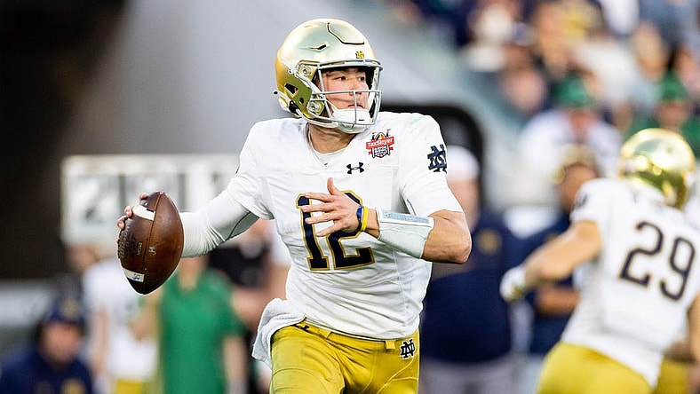 Dec 30, 2022; Jacksonville, FL, USA; Notre Dame Fighting Irish quarterback Tyler Buchner (12) looks to throw during the first half against the South Carolina Gamecocks in the 2022 Gator Bowl at TIAA Bank Field. Mandatory Credit: Matt Pendleton-USA TODAY Sports