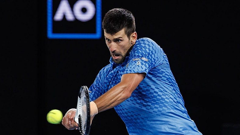 Jan 29, 2023; Melbourne, Victoria, Australia; Novak Djokovic of Serbia hits a shot against Stefanos Tsitsipas of Greece at the men's final on day fourteen of the 2023 Australian Open tennis tournament at Melbourne Park. Mandatory Credit: Mike Frey-USA TODAY Sports