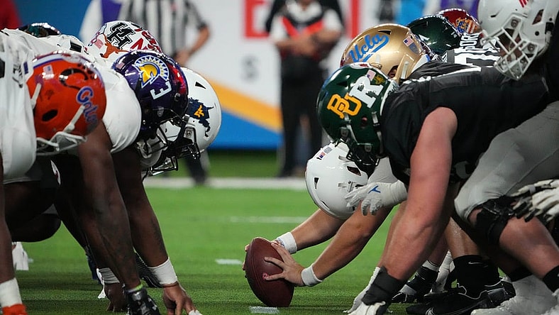 Feb 2, 2023; Las Vegas, NV, USA; A general overall view of helmets at the line of scrimmage as West long snapper Chris Stoll of Penn State snaps the ball against the East during the Shrine Bowl at Allegiant Stadium. Mandatory Credit: Kirby Lee-USA TODAY Sports