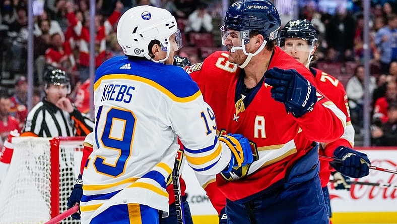 Feb 24, 2023; Sunrise, Florida, USA; Buffalo Sabres center Peyton Krebs (19) and Florida Panthers left wing Matthew Tkachuk (19) fight during the first period at FLA Live Arena. Mandatory Credit: Rich Storry-USA TODAY Sports