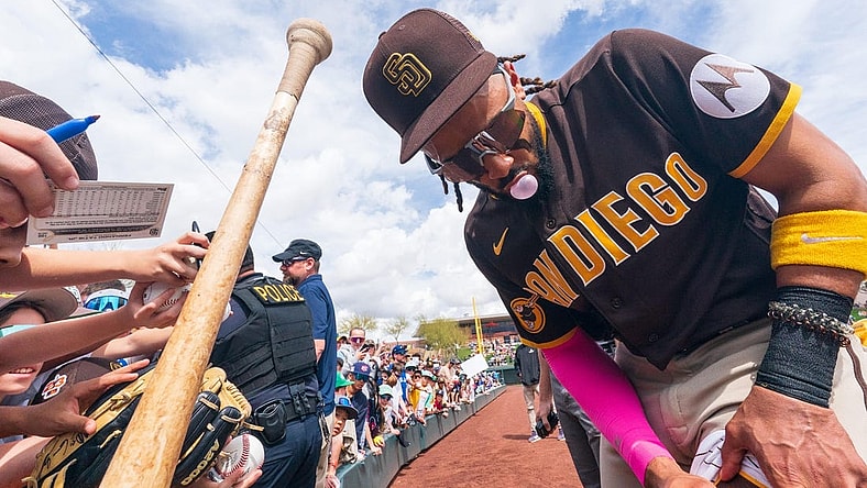 Mar 16, 2023; Salt River Pima-Maricopa, Arizona, USA; San Diego Padres outfielder Fernando Tatis Jr. (23) blows a bubblegum bubble as he signs autographs for fans before the start of the first inning for a spring training game against the Colorado Rockies at Salt River Fields at Talking Stick. Mandatory Credit: Allan Henry-USA TODAY Sports