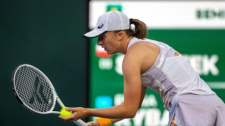Iga Swiatek of Poland prepares a serve to Elena Rybakina of Kazakhstan during their semifinal match at the BNP Paribas Open at the Indian Wells Tennis Garden in Indian Wells, Calif., Friday, March 17, 2023.