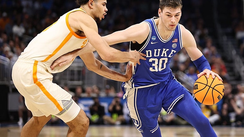 Mar 18, 2023; Orlando, FL, USA; Duke Blue Devils center Kyle Filipowski (30) drives against Tennessee Volunteers forward Olivier Nkamhoua (13) during the first half in the second round of the 2023 NCAA Tournament at Legacy Arena. Mandatory Credit: Matt Pendleton-USA TODAY Sports