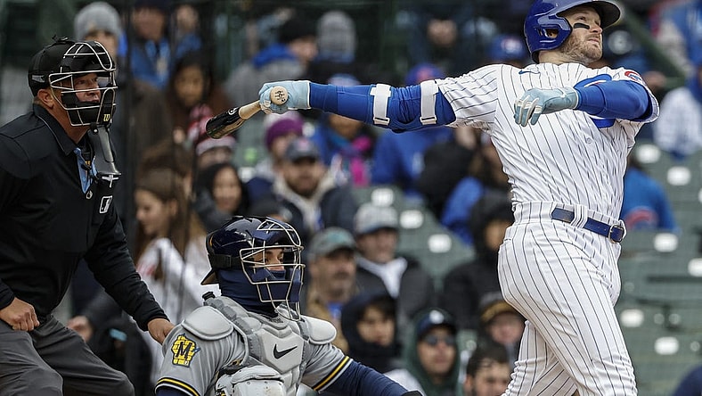 Apr 1, 2023; Chicago, Illinois, USA; Chicago Cubs left fielder Ian Happ (8) hits a solo home run against the Milwaukee Brewers during the sixth inning at Wrigley Field. Mandatory Credit: Kamil Krzaczynski-USA TODAY Sports