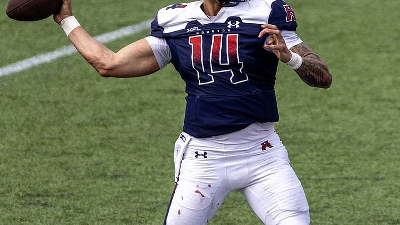 Apr 2, 2023; Houston, TX, USA;  Houston Roughnecks quarterback Cole McDonald (14) drops back to pass against the  St. Louis Battlehawks  linebacker Carson Wells (53) in the fourth quarter at TDECU Stadium. Mandatory Credit: Thomas Shea-USA TODAY Sports