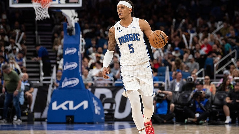 Apr 4, 2023; Orlando, Florida, USA; Orlando Magic forward Paolo Banchero (5) dribbles the ball against the Cleveland Cavaliers in the third quarter at Amway Center. Mandatory Credit: Jeremy Reper-USA TODAY Sports