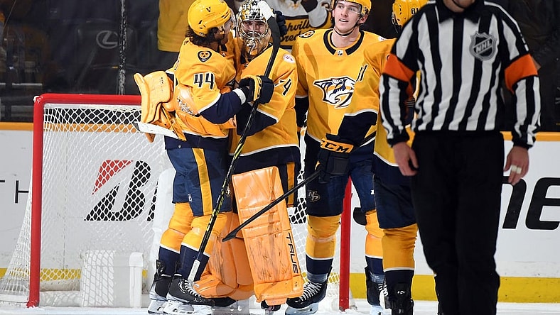 Apr 6, 2023; Nashville, Tennessee, USA; Nashville Predators goaltender Juuse Saros (74) is congratulated by left wing Kiefer Sherwood (44) and defenseman Cal Foote (52) after a shutout win against the Carolina Hurricanes at Bridgestone Arena. Mandatory Credit: Christopher Hanewinckel-USA TODAY Sports