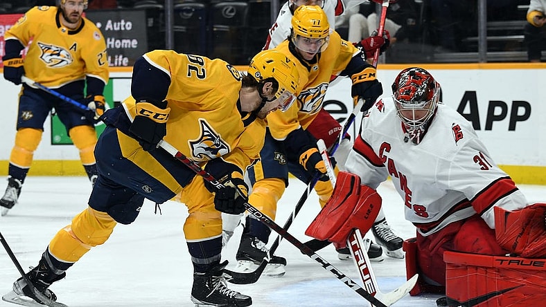 Apr 6, 2023; Nashville, Tennessee, USA; Nashville Predators center Tommy Novak (82) gets the puck past Carolina Hurricanes goaltender Frederik Andersen (31) before it is stopped on the goal line during the third period at Bridgestone Arena. Mandatory Credit: Christopher Hanewinckel-USA TODAY Sports