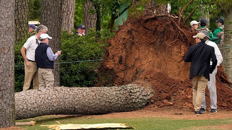 Volunteers and staff secure the area around where a tree fell near the 17th tee.
Pga Masters Tournament Second Round