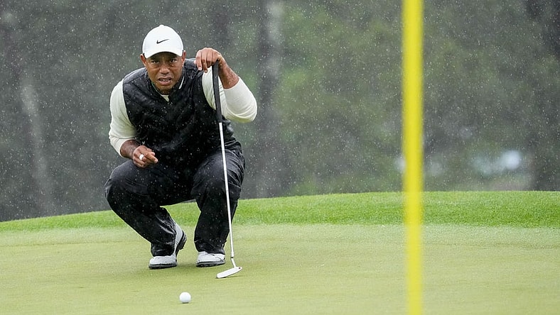 Apr 8, 2023; Augusta, Georgia, USA; Tiger Woods lines up his putt on the 18th green during the second round of The Masters golf tournament. Mandatory Credit: Rob Schumacher-USA TODAY Network