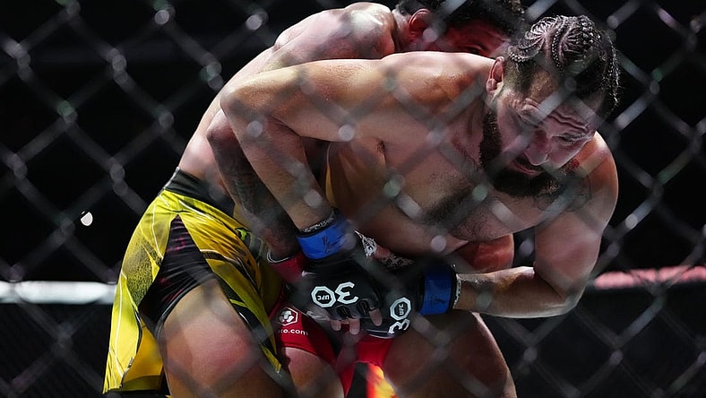 Apr 8, 2023; Miami, Florida, USA; Gilbert Burns (red gloves) fights Jorge Masvidal (blue gloves) during UFC 287 at Miami-Dade Arena. Mandatory Credit: Rich Storry-USA TODAY Sports